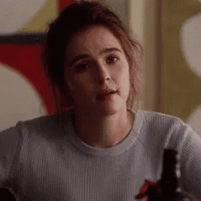 Woman In White Shirt Sitting At Table With Wine Bottle GIF
