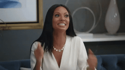 Woman In White Shirt Sitting On Blue Couch GIF