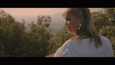 Woman In White Shirt Standing In Front Of Mountain GIF