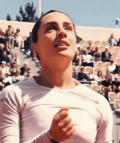 Woman In White Shirt Taking Off Shirt In Front Of Crowd GIF