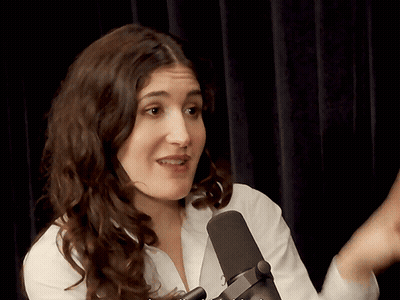 Woman In White Shirt Talking Into Black Microphone GIF
