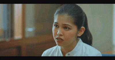 Woman In White Shirt Talking To Someone In Room GIF