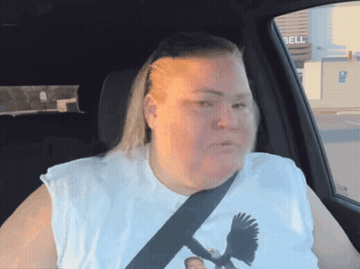 Woman In White Shirt With Bird Sitting In Car With Bell Sign GIF