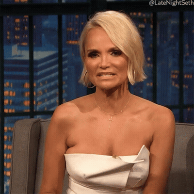 Woman In White Strapless Dress Sitting And Smiling GIF