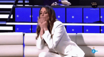 Woman In White Suit On Couch Hands Folded GIF