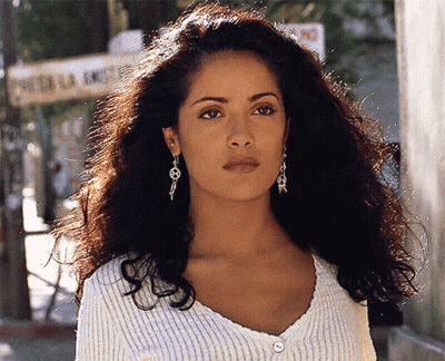 Woman In White Sweater And Earrings At Puerta La Ermita GIF