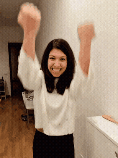 Woman In White Sweater Arms Up GIF