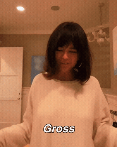 Woman In White Sweater Saying Gross GIF