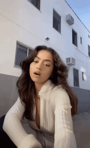 Woman In White Sweater Standing GIF