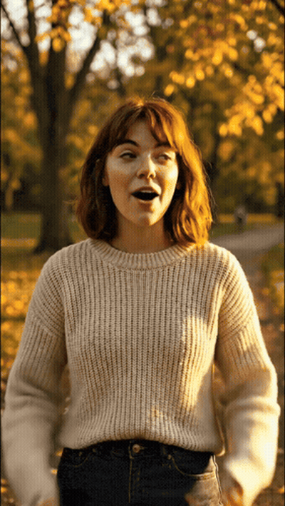 Woman In White Sweater Standing In Park GIF