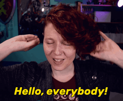 Woman In White Sweater With Gel Name Tag GIF