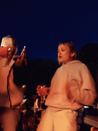 Woman In White Sweatshirt Holding Wine Glass GIF