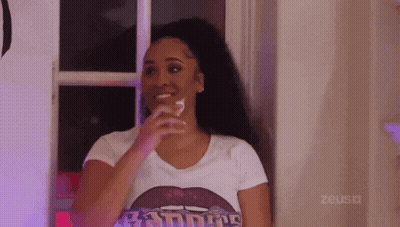 Woman In White T-Shirt Holding Glass Of Water By Window GIF