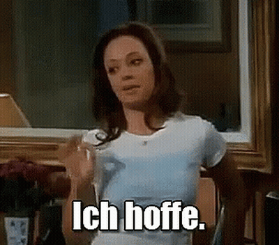 Woman In White T-Shirt Holding Glass Of Water Saying Ich Hoffe GIF