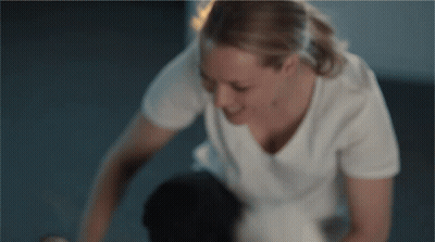 Woman In White T-Shirt Kneeling On Floor GIF