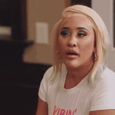 Woman In White T-Shirt Saying Virina Making Funny Face GIF