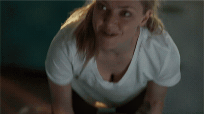 Woman In White T-Shirt Smiling At Camera GIF