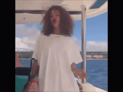 Woman In White T-Shirt Standing On Boat GIF