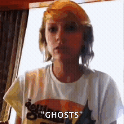 Woman In White T-Shirt Talking About Ghosts GIF