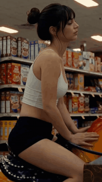 Woman In White Tank Top And Black Shorts On Motorcycle In Grocery Store GIF
