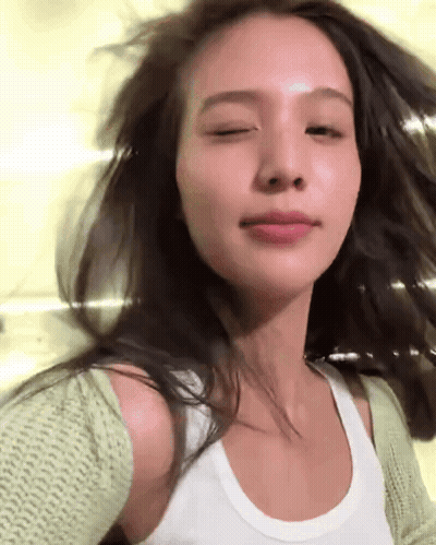 Woman In White Tank Top And Green Cardigan GIF