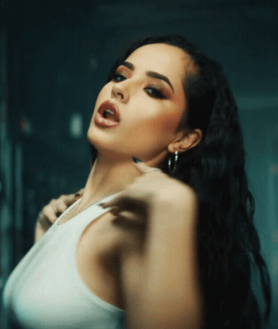 Woman In White Tank Top And Hoop Earrings Looking At Camera GIF