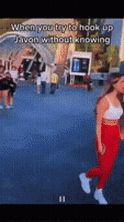 Woman In White Tank Top And Red Pants Walking GIF