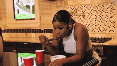 Woman in White Tank Top Eating Bowl of Food