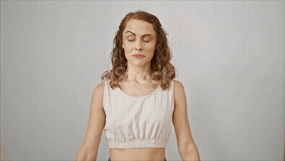 Woman In White Tank Top Flexing Biceps GIF