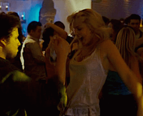 Woman In White Tank Top Holding Bottle Of Alcohol GIF