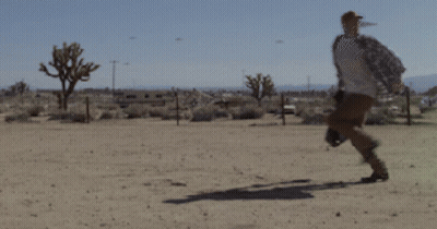 Woman In White Tank Top In Front Of 4Gifs.com Logo GIF