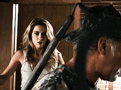 Woman In White Tank Top Next To Man In Camouflage Hat GIF