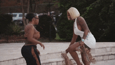 Woman In White Tank Top Next To Woman In Brown Top GIF