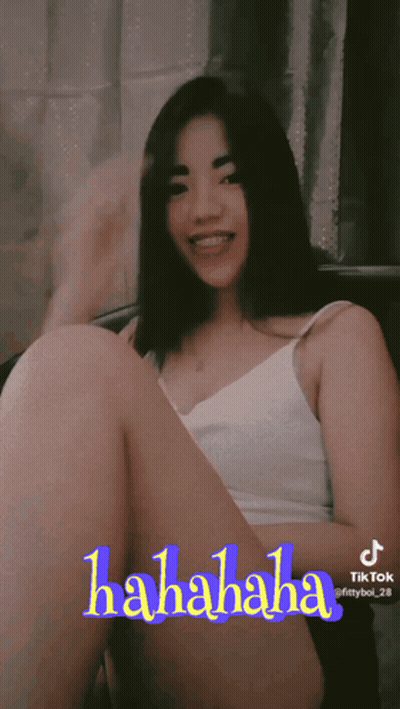 Woman In White Tank Top Sitting Cross-Legged With TikTok Hahaha Sticker GIF
