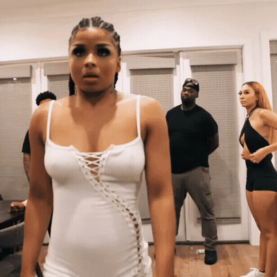 Woman in White Tank Top Standing in Room