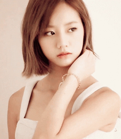 Woman In White Tank Top Touching Chin GIF