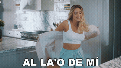 Woman In White Top And Blue Shorts Dancing In Kitchen Al La O De Mi GIF