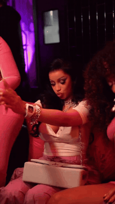 Woman In White Top And Pink Pants Holding Purse GIF