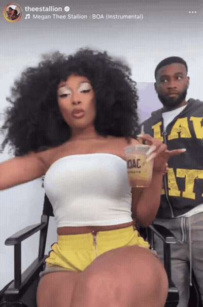 Woman In White Top And Yellow Shorts Holding OAC Cup GIF