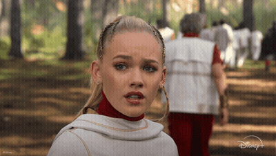 Woman In White Top In Woods With Disney Logo GIF