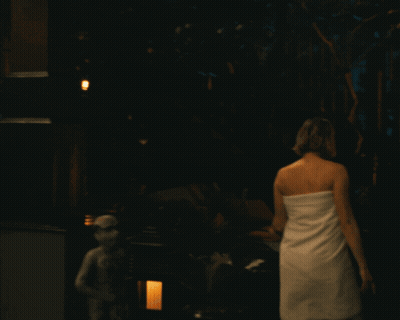 Woman In White Towel Walking Deck At Night GIF