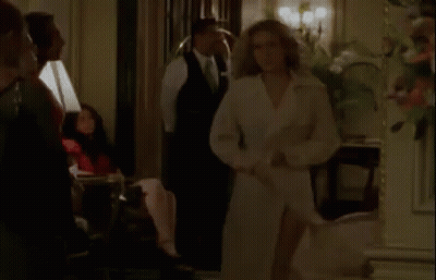 Woman In White Trench Coat Standing In Room GIF