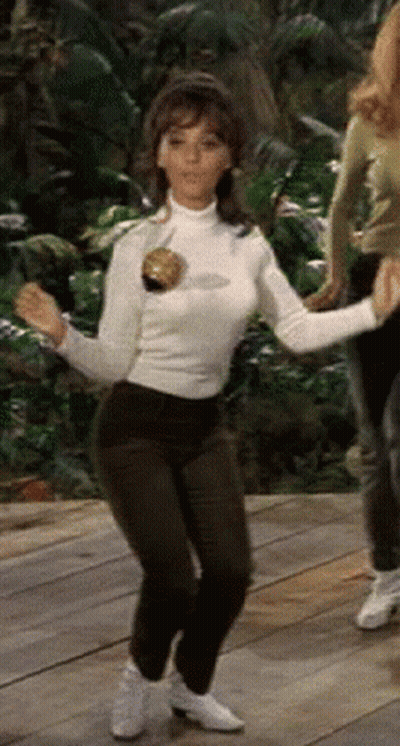 Woman In White Turtleneck Dancing On Wood Floor GIF