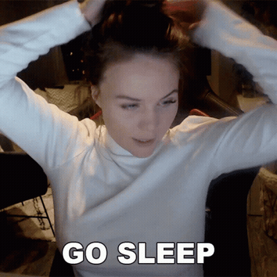 Woman In White Turtleneck Hair Bun Saying Go Sleep GIF
