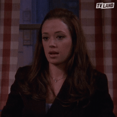 Woman In White Turtleneck In Front Of TV Land Logo GIF