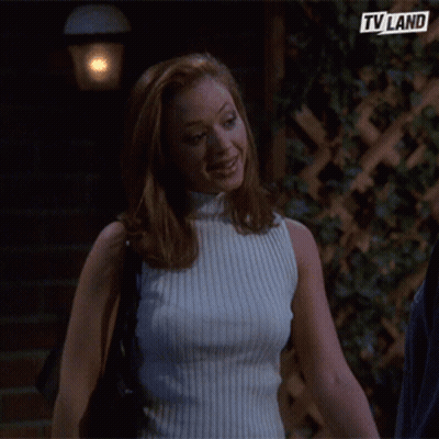 Woman In White Turtleneck In Front Of TV Land Logo GIF
