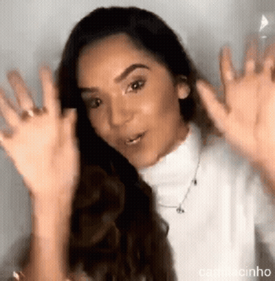 Woman In White Turtleneck Waving Hands GIF