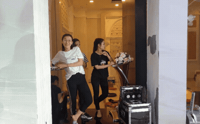 Woman In White Vans Shirt Standing In Doorway GIF