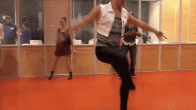 Woman In White Vest And Black Pants Dancing GIF