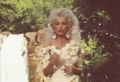 Woman In White Wedding Dress In Front Of Waterfall GIF